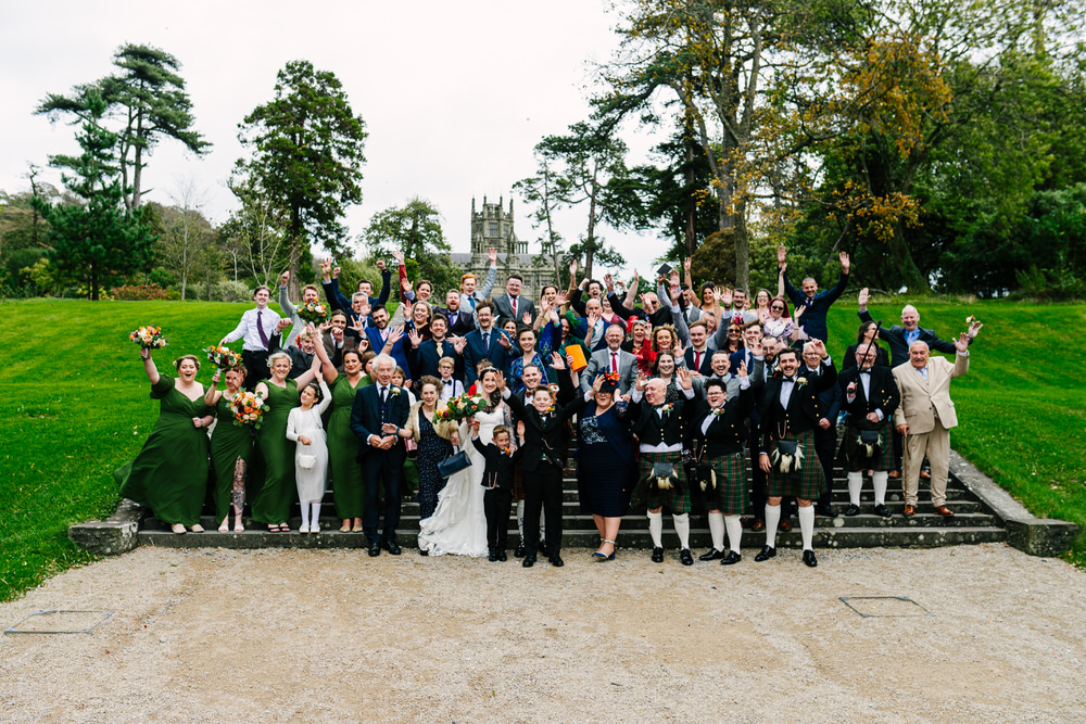 Wedding group photo in front of Margam Castle in Port Talbot